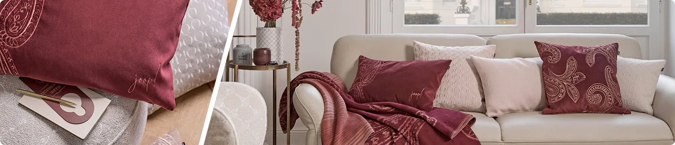 Collage aus 2 Bildern, die von einem weißen schrägen Strich getrennt werden - Bild 1: Nahaufnahme von roten Kissen mit Paisley-Muster und JOOP! Schriftzug - Bild 2: Beiges Ledersofa mit roten Kissen und roter Decke mit Paisley-Muster und JOOP! Schriftzug und cremefarbigen Kissen mit und ohne Muster und JOOP! Schriftzug, Beistelltisch und Deko