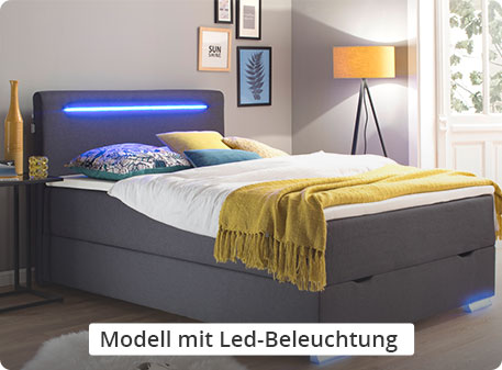 Modell mit LED-Beleuchtung - dunkelgraues Boxspringbett mit LED-Beleuchtung am Kopfteil und an den Füßen in einem Schlafzimmer