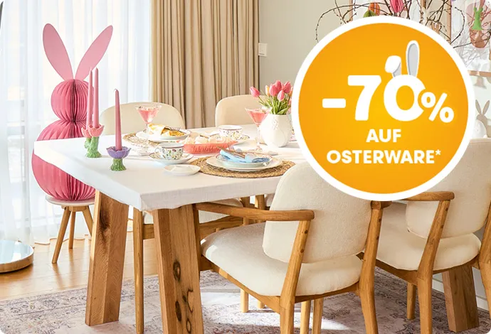 -70% auf Osterware*. Esstisch mit Polsterstühle in Weiß mit Holzfüßen, große und kleine Deko-Papierosterhasen in Wabenoptik, Äste mit Eier-und Osterhastenanhänger aus Papier in Pastelltönen, geflochtene runde Platzsets, blumiges Geschirr, Kerzenständer in Tulpenform und Pastellfarben, Dekoschalen in Pastell. 