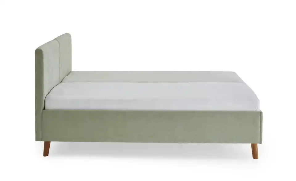 Polsterbett in hellgrün, Profilansicht