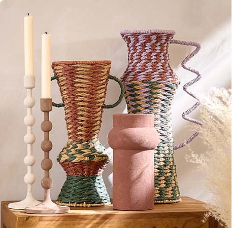 Zwei bunte Deko-Vasen aus geflochtenem Papier, braune Keramikvase, zwei Kerzenleuchter in Weiß und Braun